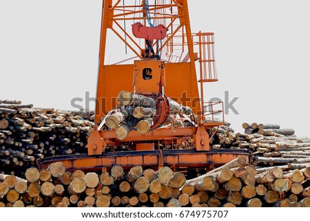 Loglift crane transferring logs to log stack 