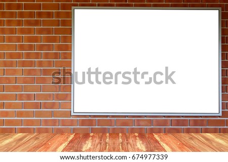 Blank photo frame on red brick wall.
