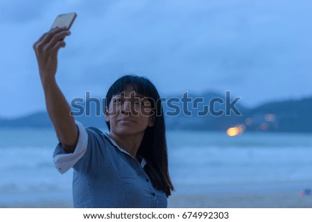 Beautiful woman taking selfie on the seaside. 