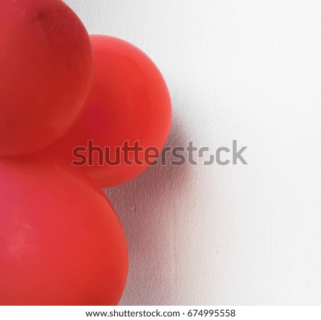 Red balloons on a white wall using wallpapers or backgrounds for a festive event.