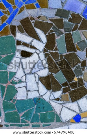 Detail of old antique mosaic with colored glass on wall of destroyed building built in 1947 in USSR. typical plot of street art of USSR period. Mass street culture of primitive Soviet poster. Mosaic