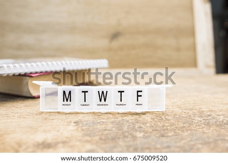 Text 7 days on plastic box Placed on wooden floor (soft focus)