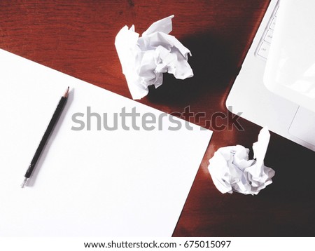 Businesses have both been successful and fail. The picture of paper, pencil, laptop, and men hand gesture above wooden table.  soft tone