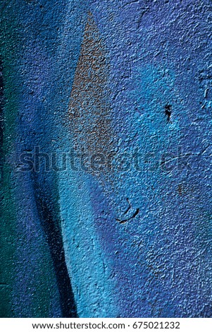 The old plastered brick wall with the remains of paint. Concrete, weathered, worn out wall is damaged by paint. Abstract background for creative design