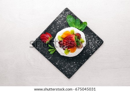 Desart with fresh strawberries and mint. Italian cuisine. Top view. On Wooden background.