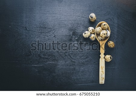Quail eggs. Wooden background. Top view. Free space.