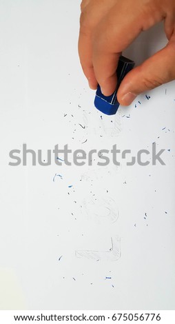 eraser removing a written mistake of love on a piece of paper, delete by hand, and mistake love concept. 