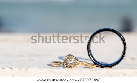 a couple of wedding rings on the beach