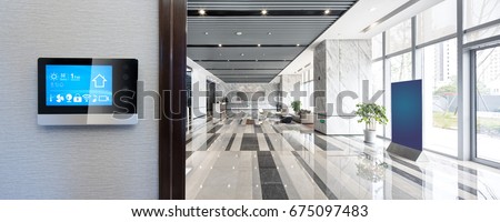 smart screen on wall with spacious hall in modern office building Royalty-Free Stock Photo #675097483
