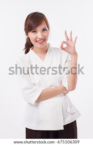 spa therapist giving ok hand gesture