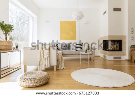 Spacious white and wooden living room with modern fireplace and sofa Royalty-Free Stock Photo #675127333