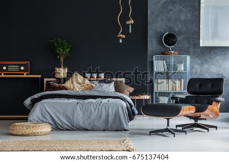 Wicker accessories in black and grey modern bedroom Royalty-Free Stock Photo #675137404