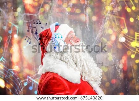 Santa Claus with headphones listening to music on blurred lights background. Christmas and New Year songs