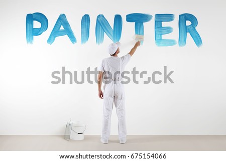 painter man with paint brush drawing a blue painter text isolated on the blank white wall