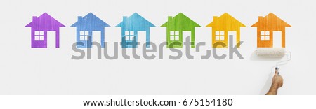 paint roller hand with colors house symbol painting on wall isolated on white web banner