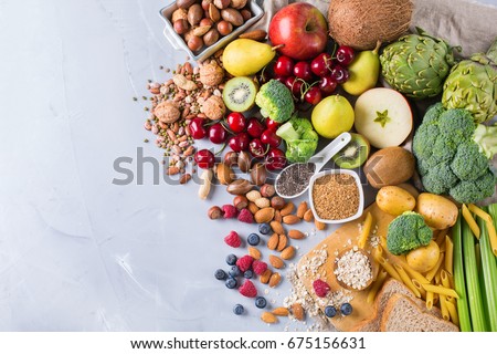 Healthy balanced dieting concept. Selection of rich fiber sources vegan food. Vegetables fruit seeds beans ingredients for cooking. Copy space background, top view Royalty-Free Stock Photo #675156631