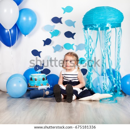 Beautiful pretty happy girl and holiday decoration in marine style for children's birthday, indoor