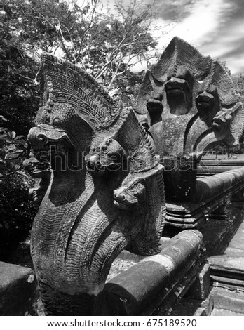Naga head sculptured to protect Phanom Rung temple of Khmer Brahmanism. Consisting of five heads facing temple with grim gaze made from sand stone. Picture was taken with black and white monochrome.