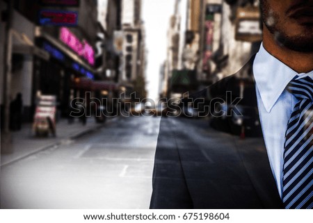 Mid section of serious businessman against picture of a city