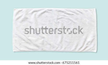 White beach towel mock up isolated with clipping path on blue background, flat lay top view  Royalty-Free Stock Photo #675211561