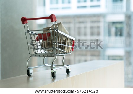 Shopping cart full of cardboard Paper boxes. Trolley with gifts The concept of shopping. Selective focus.