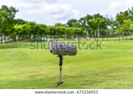 Professional microphone for record golf sport on green grass