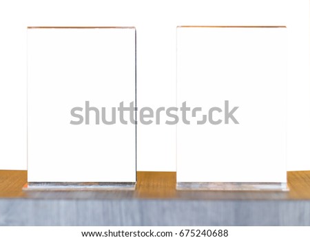 Mock up Menu frame in Bar restaurant ,Stand for booklets with white sheets of paper acrylic tent card on wooden table on  Isolated on white