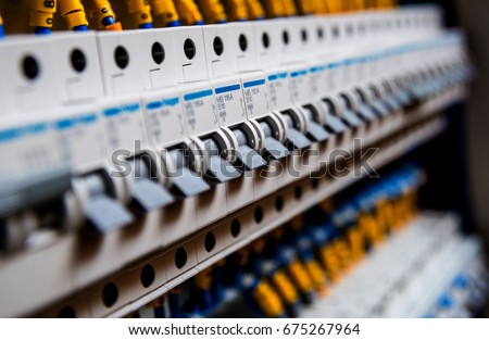 Voltage switchboard with circuit breakers. Electrical background Royalty-Free Stock Photo #675267964