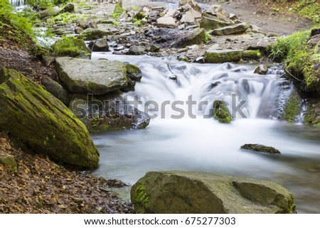 Mountain stream flowing among the mossy stones. Carpathians, Ukraine
