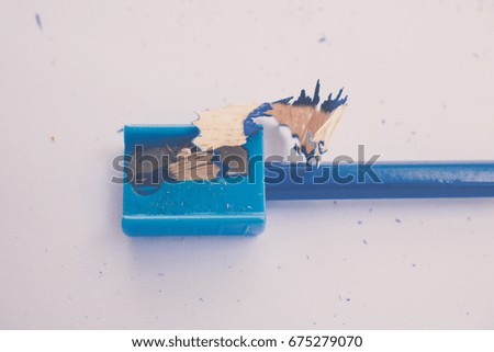 color pencil with sharpening shavings on white background,warm tone