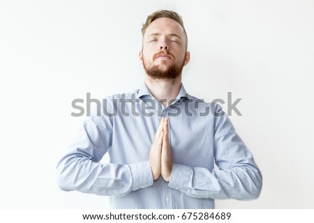 Focused Man Keeping Hands Together and Praying