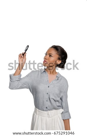 Attractive young african american woman looking at magnifier isolated on white