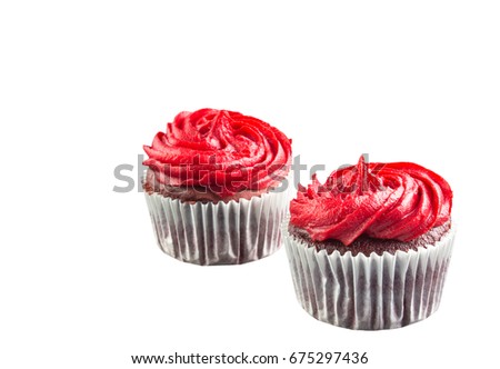 Two red velvet cupcakes isolated on white background