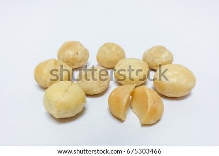 Peeled salted macadamia nuts isolated on white background
