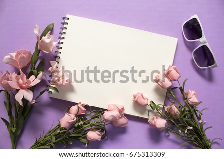 Flat lay with roses and sunglasses on violet background. Romantic pink flower bouquet. White paper notepad with text place. Wedding or marriage anniversary card template. Feminine banner or mockup
