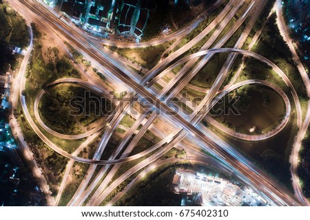 The light on the road roundabout at night and the city in Bangkok, Thailand. Aerial view. Top view. Background scenic road.