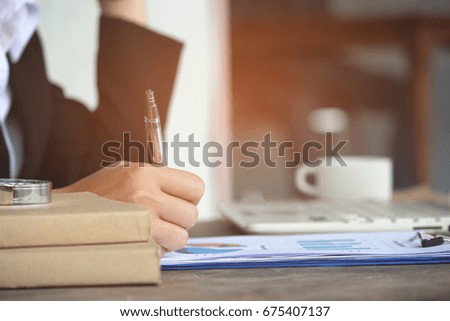 digital tablet computer docking keyboard with business man gavel and document on wood table