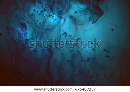 Abstract ocean. Dark clouds. Luminescent. Underwater marvel. An experiment with water and ink. Fluorescent paint. Wonderful blue colors. Abstract background. Best colors. Good combination