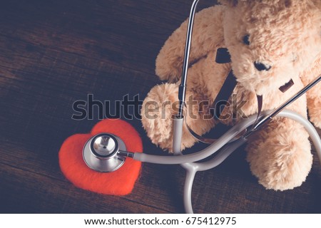 Health Care teddy bear Heart stethoscope with filter effect retro vintage style Royalty-Free Stock Photo #675412975