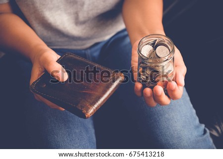 save money for investment concept Hand holding money in jar with filter effect retro vintage style
