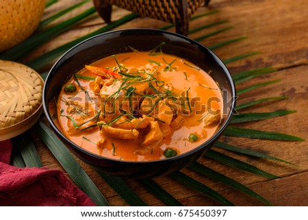 Chicken in curry sauce in a pan with the ingredients on the old desk,adjustment size for banner,cover and header. Royalty-Free Stock Photo #675450397