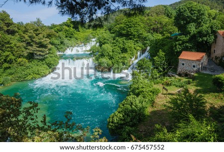 The Waterfalls of Krka National Park, Croatia with tiny house with the orange roof