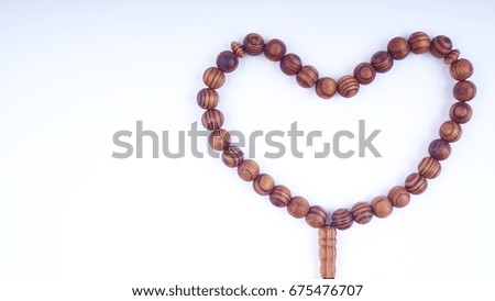 Closeup of  tasbih or rosary on a white background. Selective focus, crop segment and copy space.
