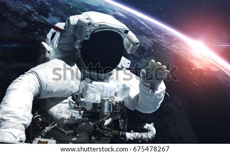 Astronaut. Abstract space wallpaper. Universe filled with stars, nebulas, galaxies and planets. Elements of this image furnished by NASA