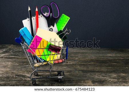 Shopping cart with school supplies. Back to school.