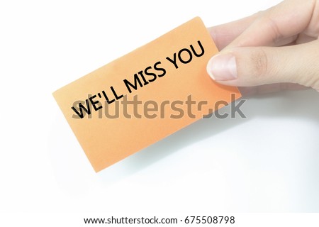 hand holding orange business card written We'll Miss You over isolated