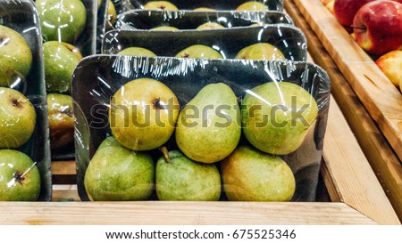 Green apples packed under plastic film Royalty-Free Stock Photo #675525346