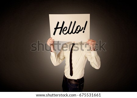 Young businessman hiding behind a greeting drawn on paper