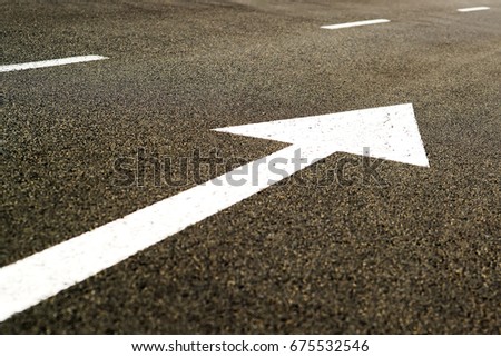 arrow road sign in highway asphalt 