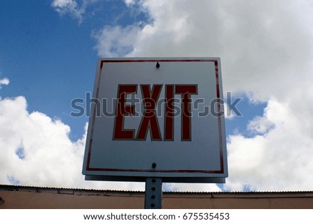 Exit sign with clouds and skies background